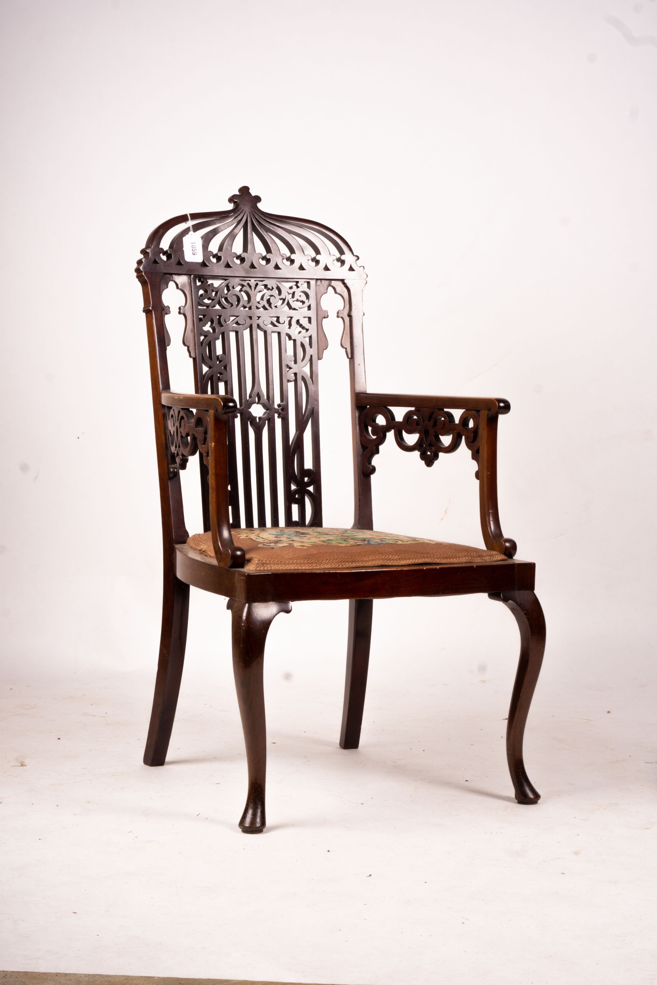 A late Victorian carved mahogany elbow chair